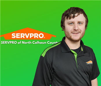 pic of man smiling on a green background with an orange SERVPRO logo